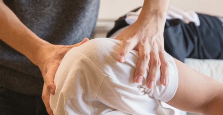 Patient receiving treatment for shoulder impingement syndrome at District Wellness, Arlington, VA